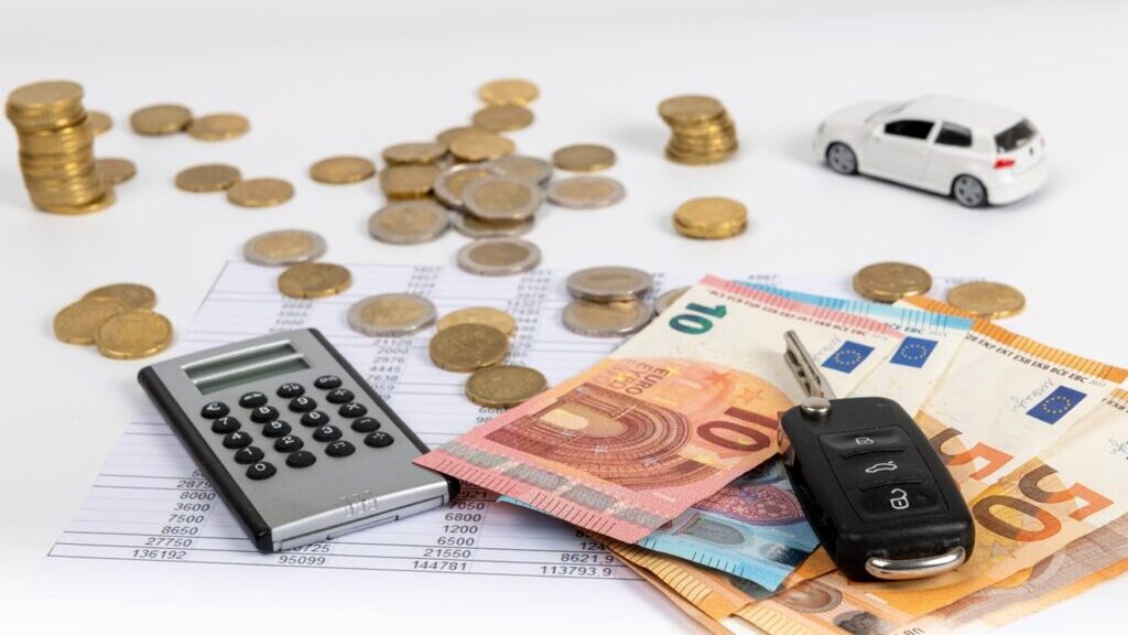 Financial statement with coins and banknotes. Finance and car key, saving money for a car or material design concepts.